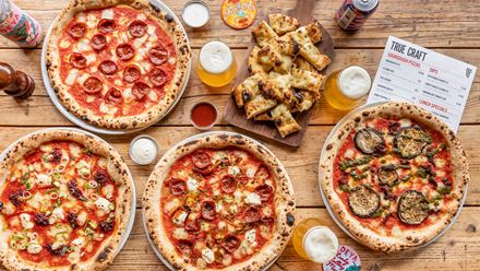 Tuck into tasty sourdough pizzas, created with flavourful toppings and homemade dough. Credit: True Craft. Image courtesy of True Craft.