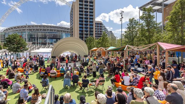A crowd gathers at Wembley Park for Summer Rocks, a free summer programme packed with live music, cultural events, family activities and outdoor entertainment. I