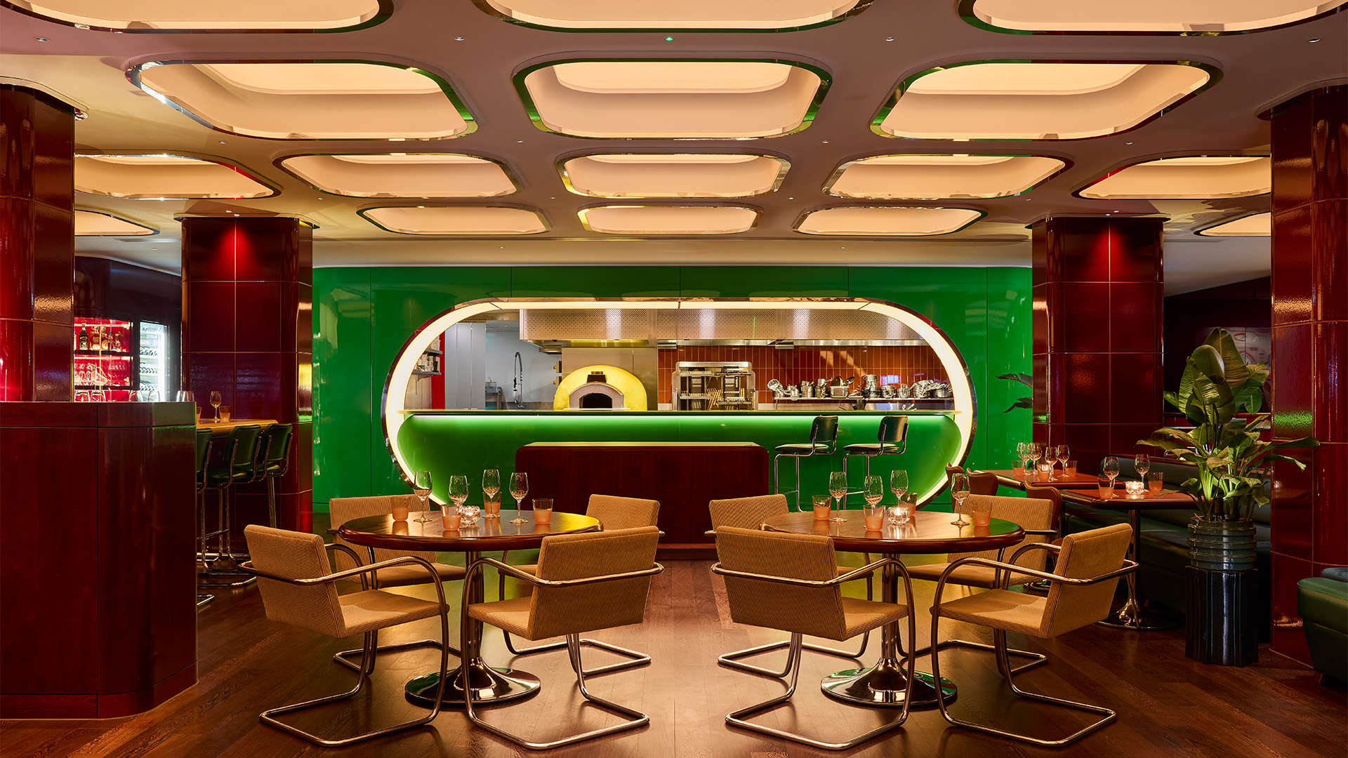 Potted plants, yellow chairs and a green bar decorate the space at Town restaurant 