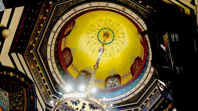 An upside-down view of the dome, intricate mosaics and architecture of the Arab Hall at Leighton House.