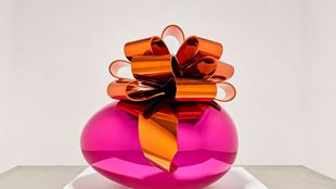 Smooth and shiny pink egg with orange bow