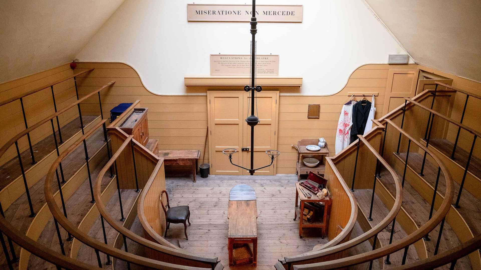 The reconstructed operating theatre at The Old Operating Theatre and Herb Garret Museum, with a wooden surgical table in the middle and tiered standing around the sides.