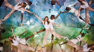 Two children standing in illusion room with multiple reflections of themselves surrounding them.