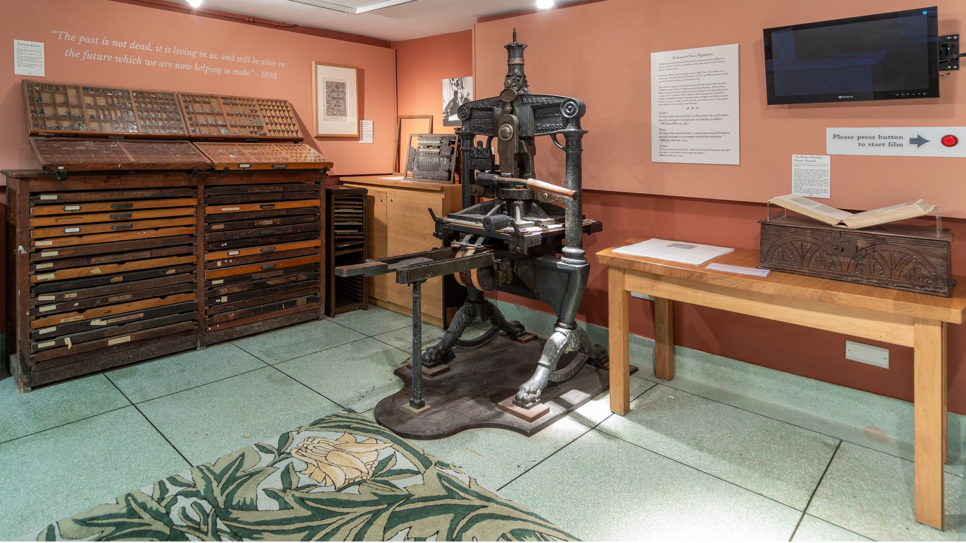 The original printing press at The William Morris Society's Kelmscott House and a cabinet with drawers behind.