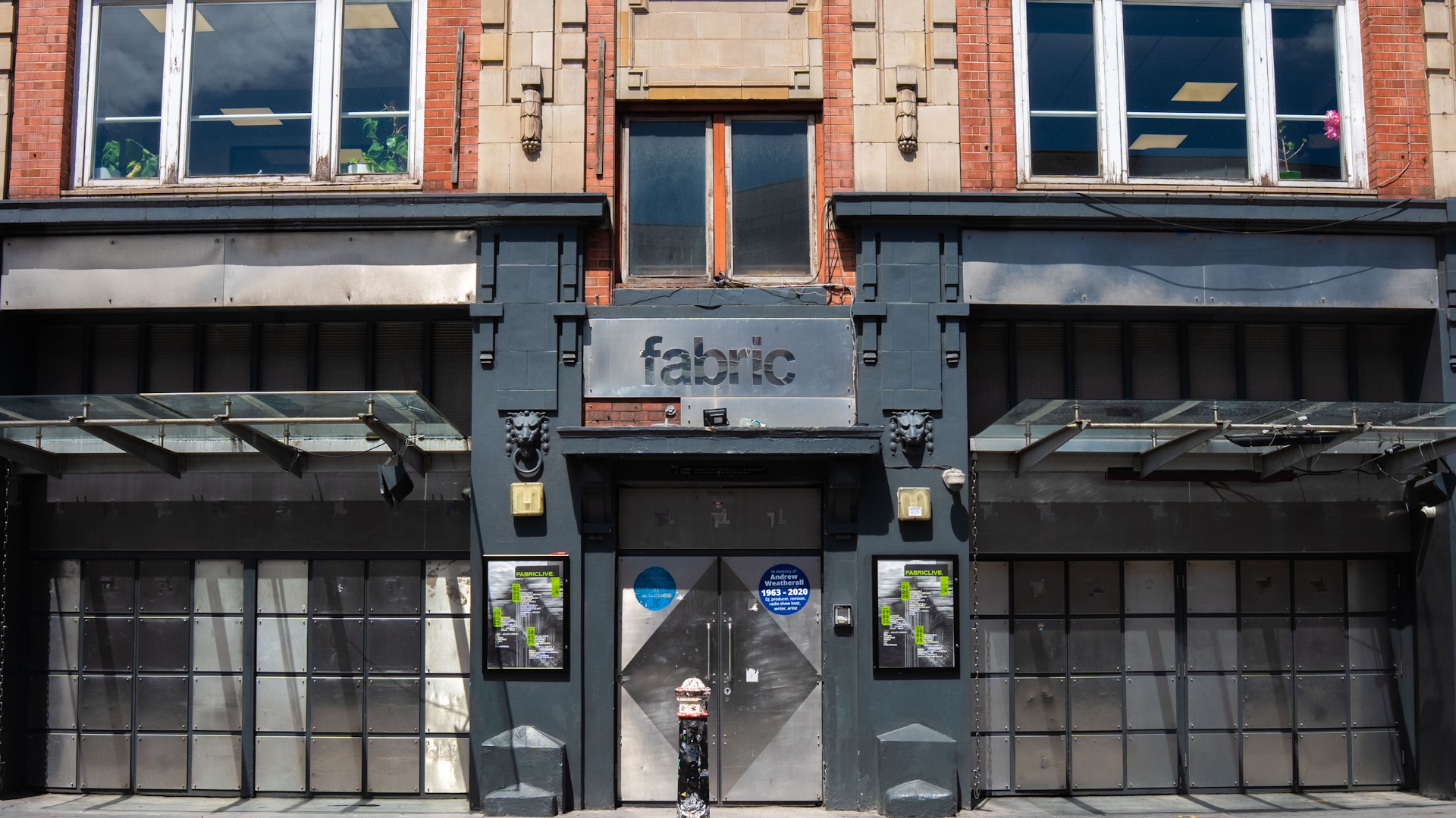 Exterior sign and red-brick building at Fabric nightclub in Farringdon, London.
