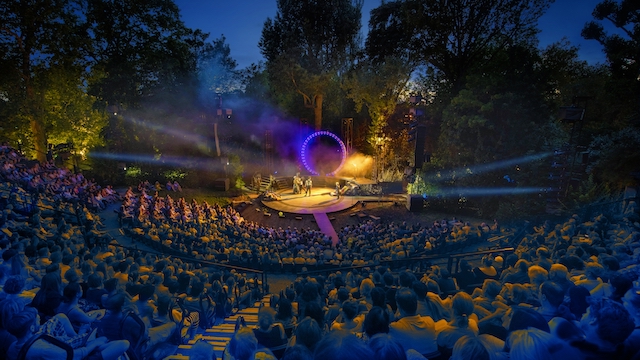 Spectators watch a theatre performance at the Open Air Theatre in Regent's Park in central London.