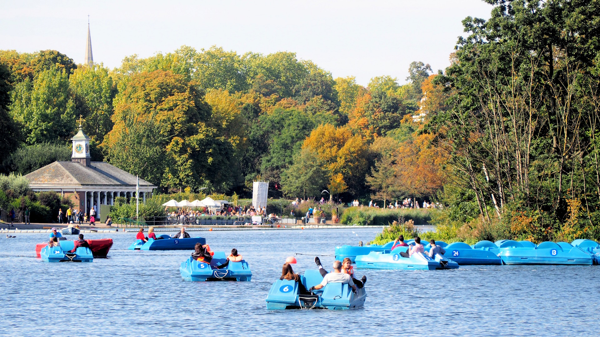 HIre a pedalo or row boat for a gentle ride on the scenic Serpentine in Hyde Park. Credit: Shutterstock. Image courtesy of Shutterstock. Groups of people on pedalos on the Serpentine in Hyde Park in London on a sunny day.