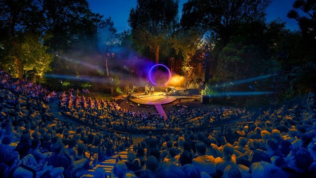 An audiences watches Shakespeare's A Midsummer Night's Dream at the Regent's Regent's Park Open Air Theatre Auditorium in London