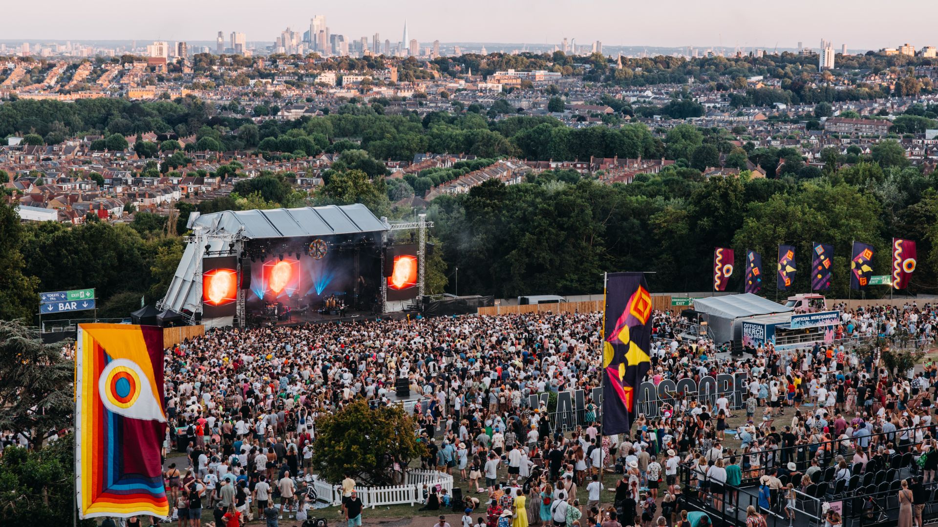 Crowds at the main stage of Kaleidoscope Festival in Alexandra Palace Park, with a view of the London skyline.