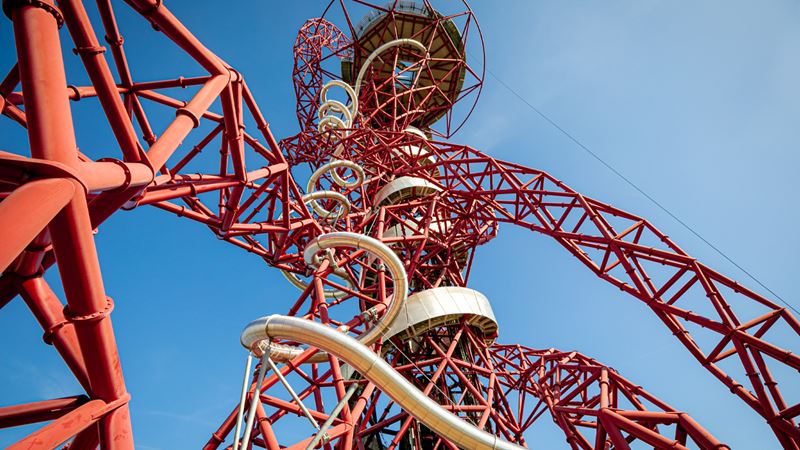 Zip down the world’s longest and tallest tunnel slide at Zip World London’s ArcelorMittal Orbit. Credit: London Legacy Development Corp. Image courtesy of London Legacy Development Corp. A view of the ArcelorMittal Orbit taken from below with blue sky in the background.