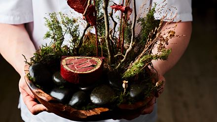 A dish of food decorated with foliage. Credit: Steven Joyce. Image courtesy of CORD.