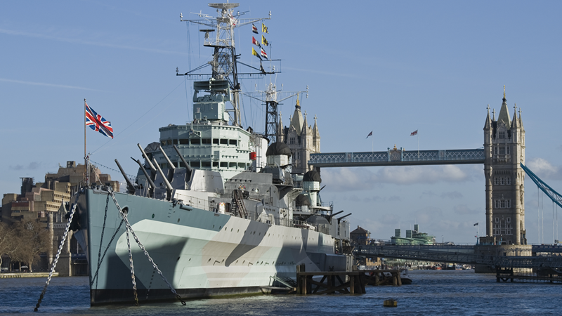 HMS Belfast with Tower Bridge in the background. Photo: Richard Ash. Image courtesy of IWM.