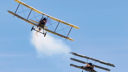 Historic aircraft fly in formation during an air display at IWM Duxford. Image courtesy of Golden Tours.