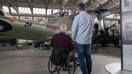 Visitors explore historic aircraft exhibits inside the Imperial War Museum Duxford. Image courtesy of Golden Tours.