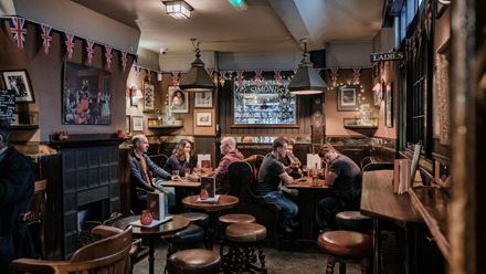 People sitting at tables in the Lamb & Flag. Credit: Thomas Skovsende. Image courtesy of Fuller's.