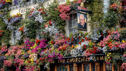 Flowers covering the front of The Churchill Arms. Credit: Fuller’s. Image courtesy of Fuller’s.