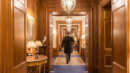 A butler carrying a room service tray. Image courtesy of The Lanesborough.