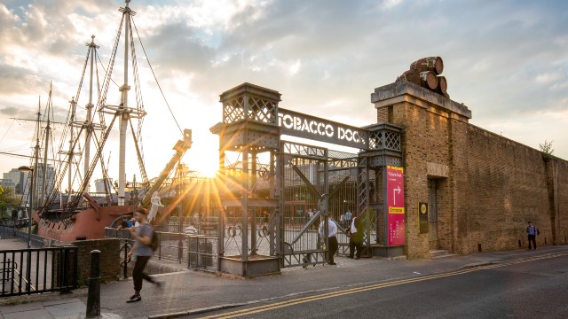 Tobacco Dock at dusk. Image courtesy of Antoine Buchet. Tobacco Dock building at dusk with ships in the background.