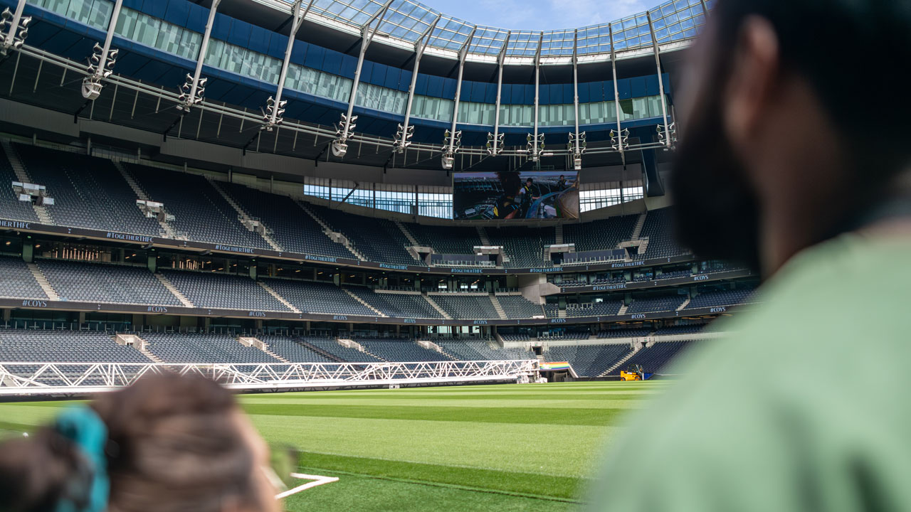 See Tottenham Hotspur Stadium from above with The Dare Skywalk experience. Image courtesy of Michael Barrow. Two people are looking up the pitch of the Tottenham Hotspur stadium during one of the tours.
