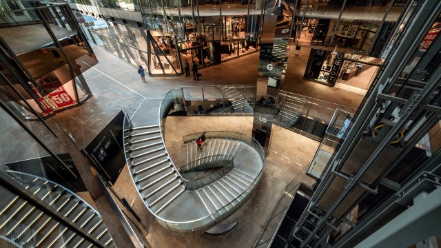 One New Change. ©Antoine Buchet/visitlondon.com. Bird's-eye view of twisting staircase, lifts and shops at One New Change in London.