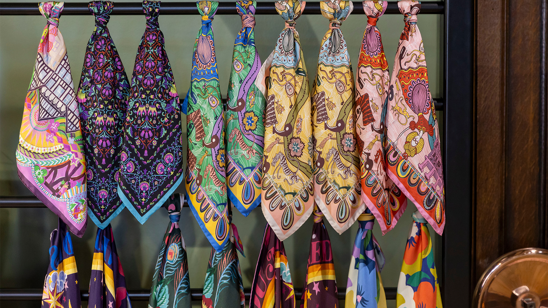 Colourful and patterned silk scarves hanging in Liberty