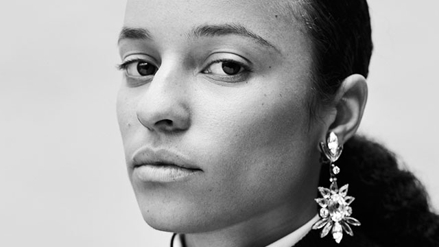 A close-up black-and-white image of Grace Wales Bonner, looking into the camera.