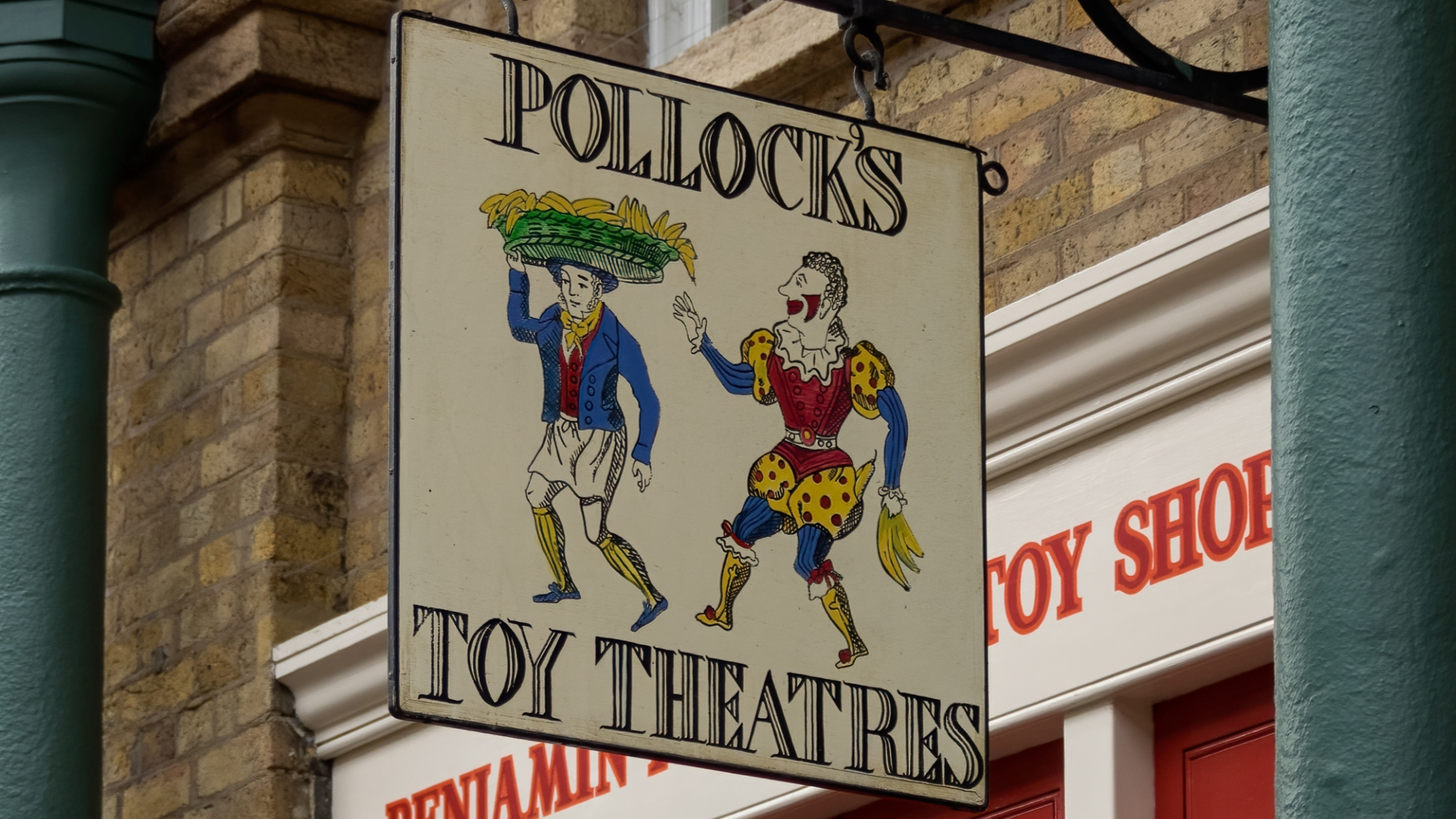 The old fashioned sign hanging outside the Benjamin Pollock Toyshop in Camden's covered market that reads "Pollock's Toy Theatres"