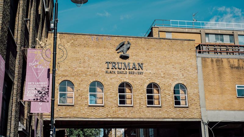 From music festivals and gigs to retro games and plenty of food and drink spots, the Brick Lane area is filled with things to do all year. Credit: Cheungjoproduction. Image courtesy of Shutterstock. Black Eagle Brewery's brick building with blue sky.