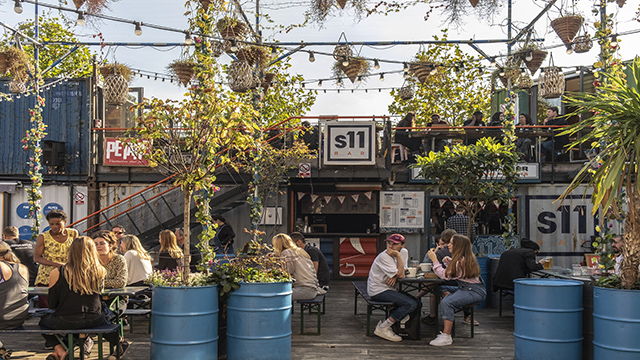 Shops  and bars inside shipping containers on a sunny day at Pop Brixton, London