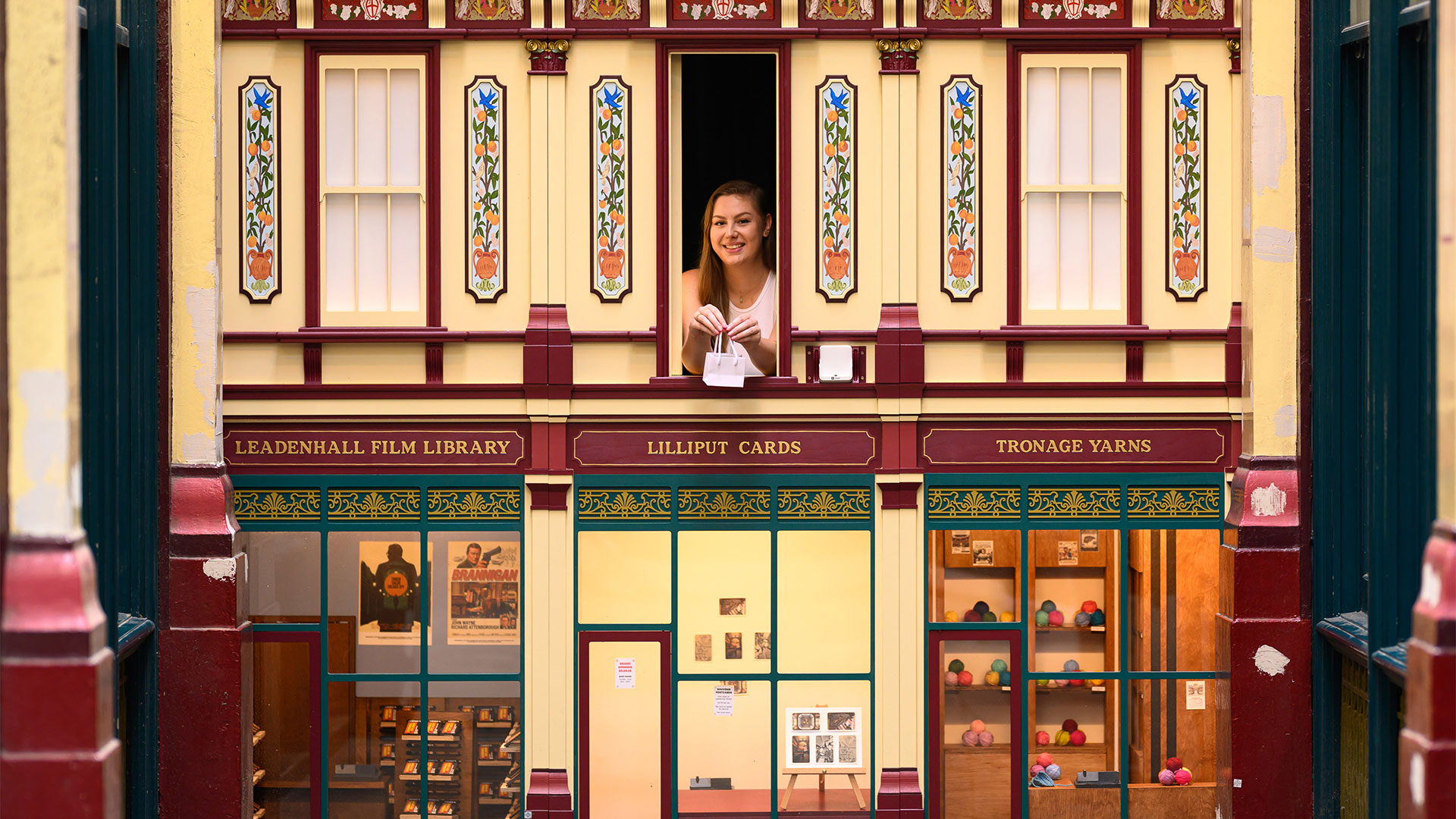 A woman appears at the window of Wunderkammer, a curiosity cabinet shop in Leadenhall Market.