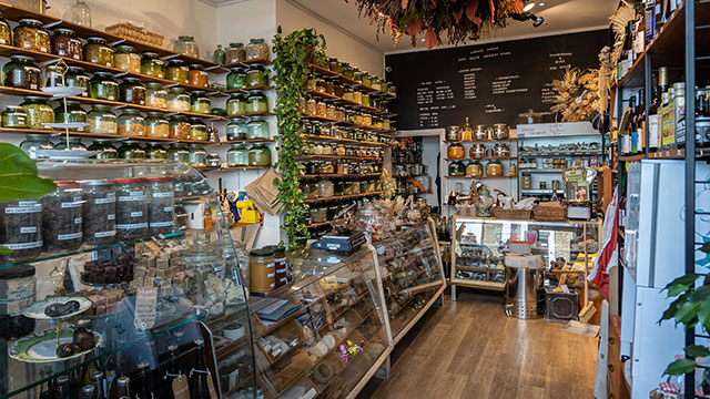 Nachhaltiger Zero-Waste-Lebensmittelladen Liberté Chérie in Notting Hill. © Alex Scott Perry. Bild mit Genehmigung von Alex Scott Perry / Liberté Chérie. Das Ladeninnere des Zero-Waste-Ladens Liberté Chérie, gefüllt mit Gläsern und Lebensmitteln aus der Region