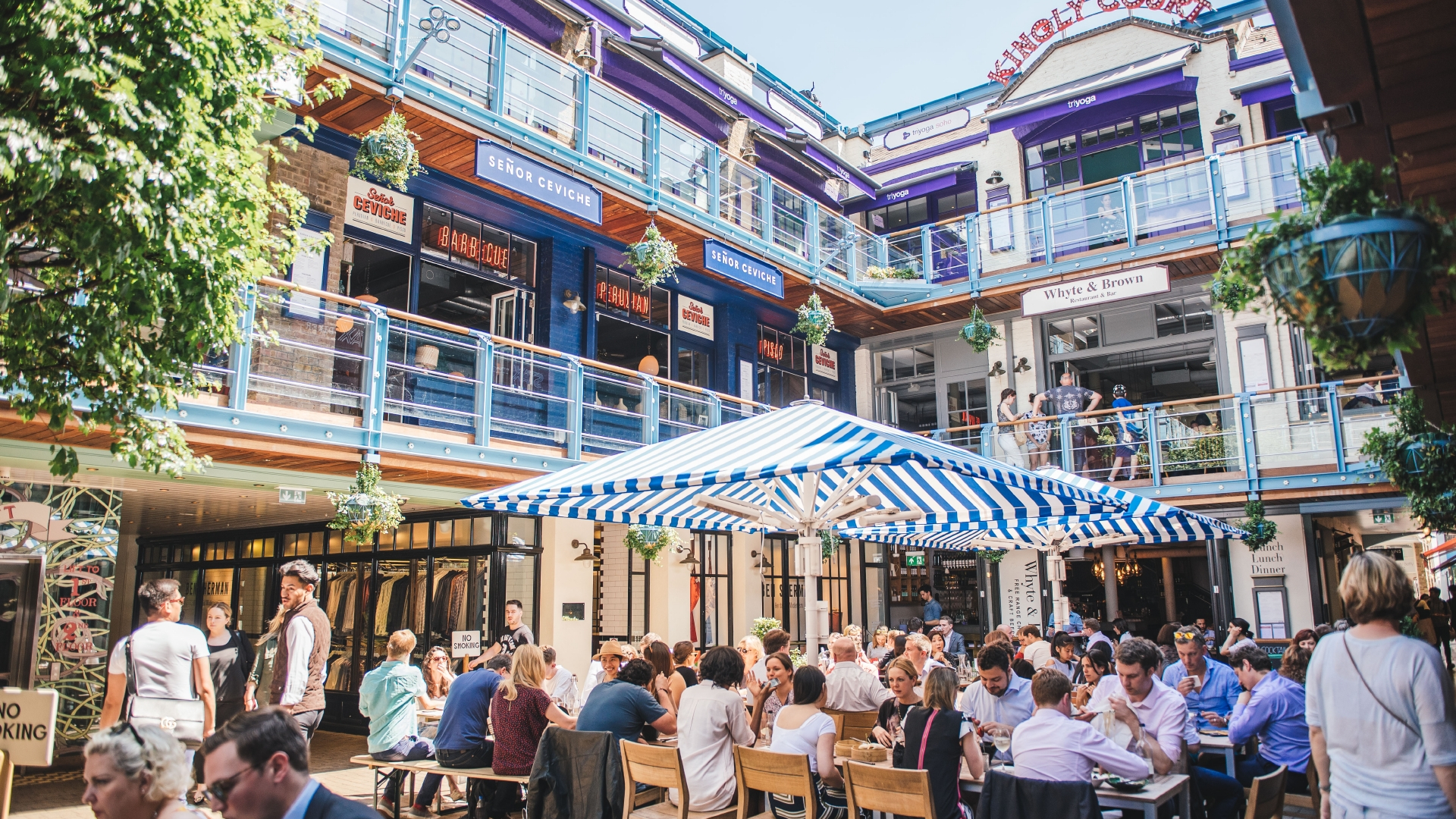 People eating out in London's Kingly Court in summer.