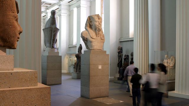 Visitors admiring Egyptian sculptures at the British Museum in London.