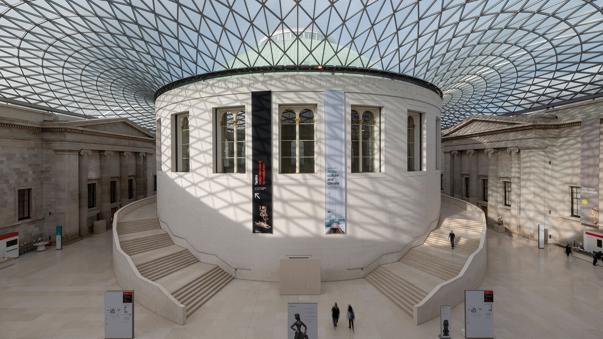 The Great Court at the British Museum, with daylight peering through the glass roof, white walls and white staircases winding their way around the main building.