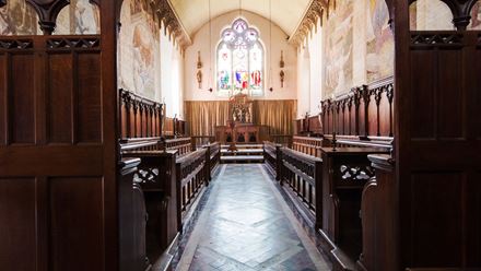 Admire the beautiful historic interior of Fulham Palace Chapel, with its ornate woodwork, medieval-style murals and stained-glass window. Image courtesy of Fulham Palace. Photo credit: Kajsa Kax.