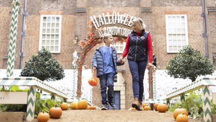 Enjoy a family-friendly Halloween adventure at Hampton Court Palace, surrounded by pumpkins and historic royal architecture. © Historic Royal Palaces
