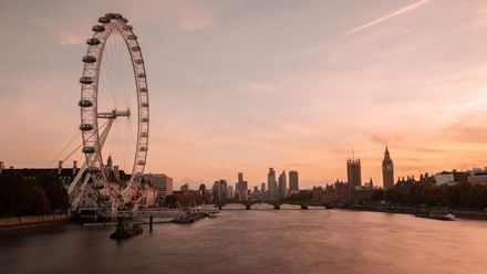 Take in golden-hour views from the London Eye as the city skyline glows at sunset. Image courtesy of Merlin.