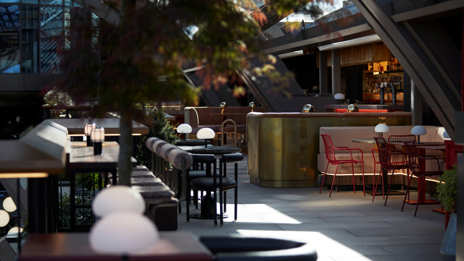 A photo of the interior at Wolves of Tokyo with stylish modern touches, bar seating and indoor plants 