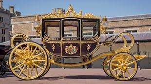 the Diamond Jubilee state coach, adorned with gold decorative detailing on the wheels, rims and coach