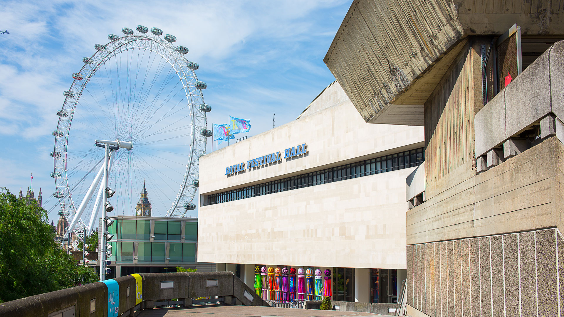 The exterior of the Southbank Centre and Royal Festival Hall, with the London Eye in the background on a sunny day