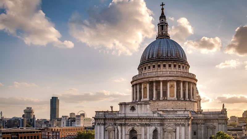 Admire St Paul's Cathedral, a key monument on the London skyline, and a site of numerous historic events. Credit: Shutterstock. Image courtesy of Shutterstock. The exterior of St Paul's Cathedral, with its iconic grey-coloured dome, against a bright sky with the sun shining through clouds.