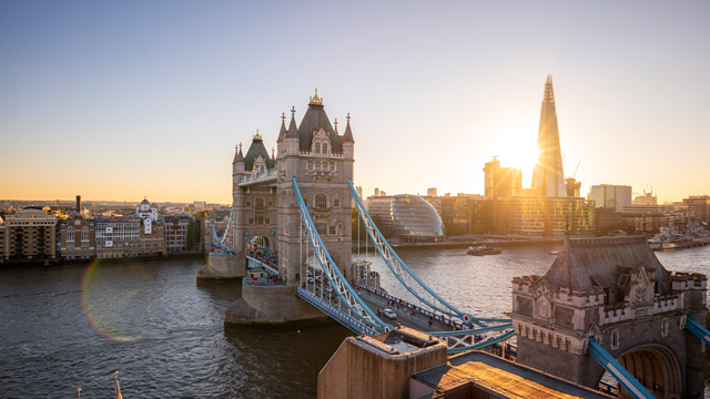 The sun rising behind The Shard and Tower Bridge