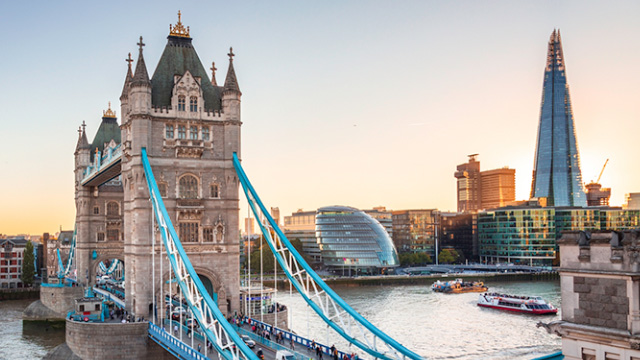 A view across the river Thames, including Tower Bridge, City Hall and The Shard on a bright day.