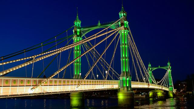 Albert Bridge lit up in green and gold at night