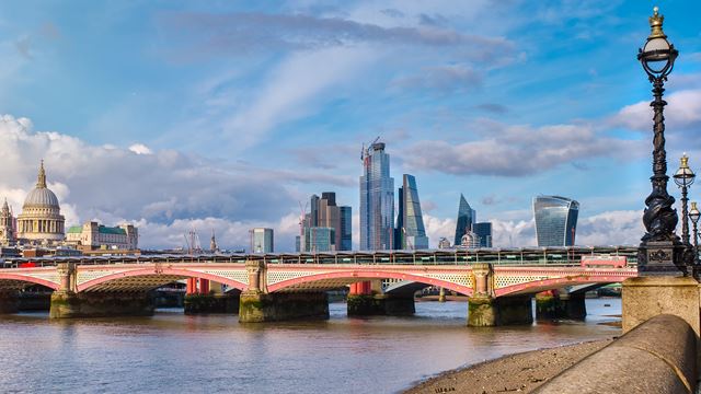 Views of the Thames and Blackfriars Bridge with St. Paul's Cathedral and the city skyline in the background on a sunny day