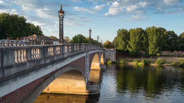 Hampton Court Bridge spanning the river Thames on a sunny day