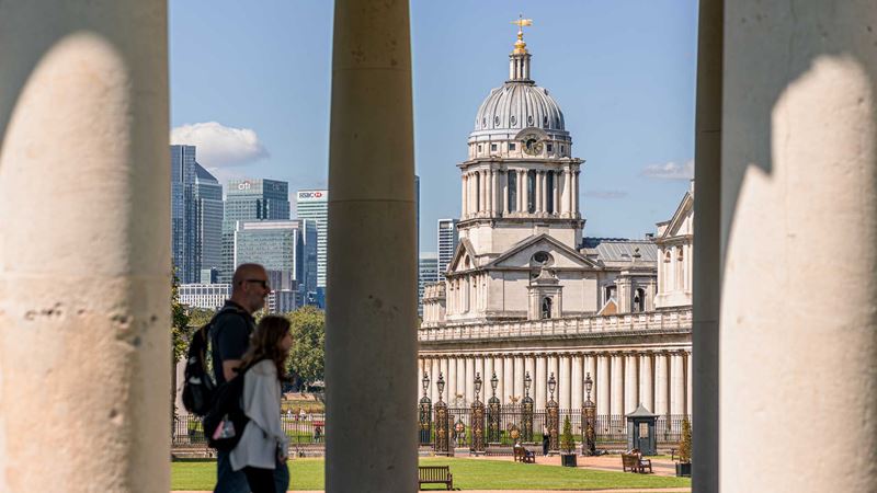 Wander around the grounds of the Old Royal Naval College which has set the stage for many famous films. Credit: London & Partners/Michael Barrow. Image courtesy of London & Partners. Two people walking past the Old Royal Naval College in Greenwich.