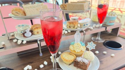 Tuck into a festive afternoon tea aboard The Snowman™-themed bus, complete with sweet treats, savoury bites and hot drinks. Image courtesy of Golden Tours.