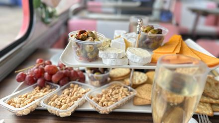 Indulge in a delicious selection of European wines and cheese aboard the London Wine Tasting Bus Tour. Image courtesy of Golden Tours.
