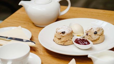 Enjoy a traditional British tea experience and tuck into scrumptious scones with fresh clotted cream and jam at Beatrix Potter’s family home. Image courtesy of Golden Tours.